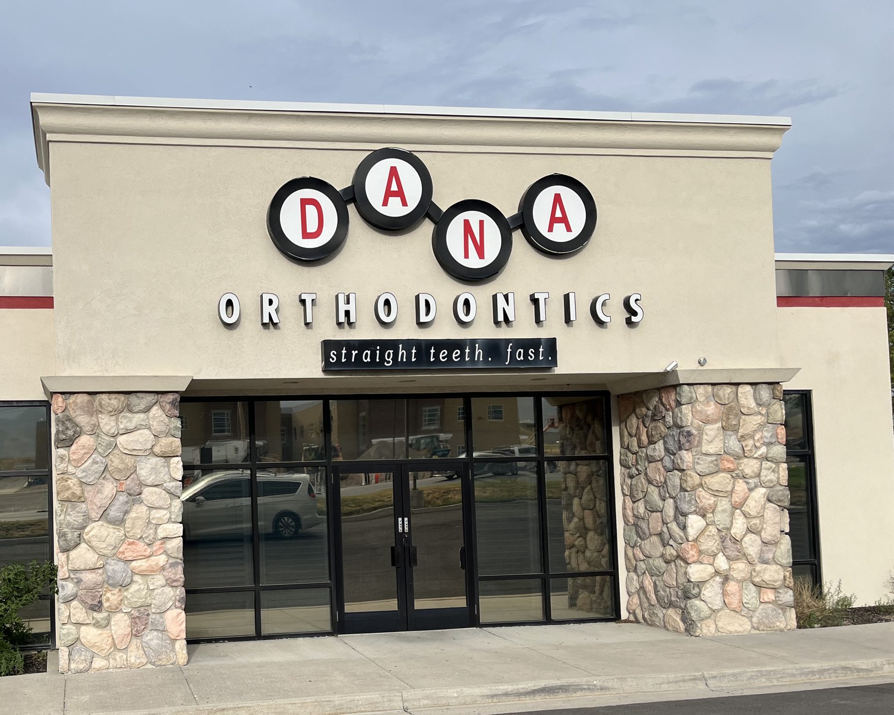 Commercial storefront with dark, evenly finished window film across the full facade