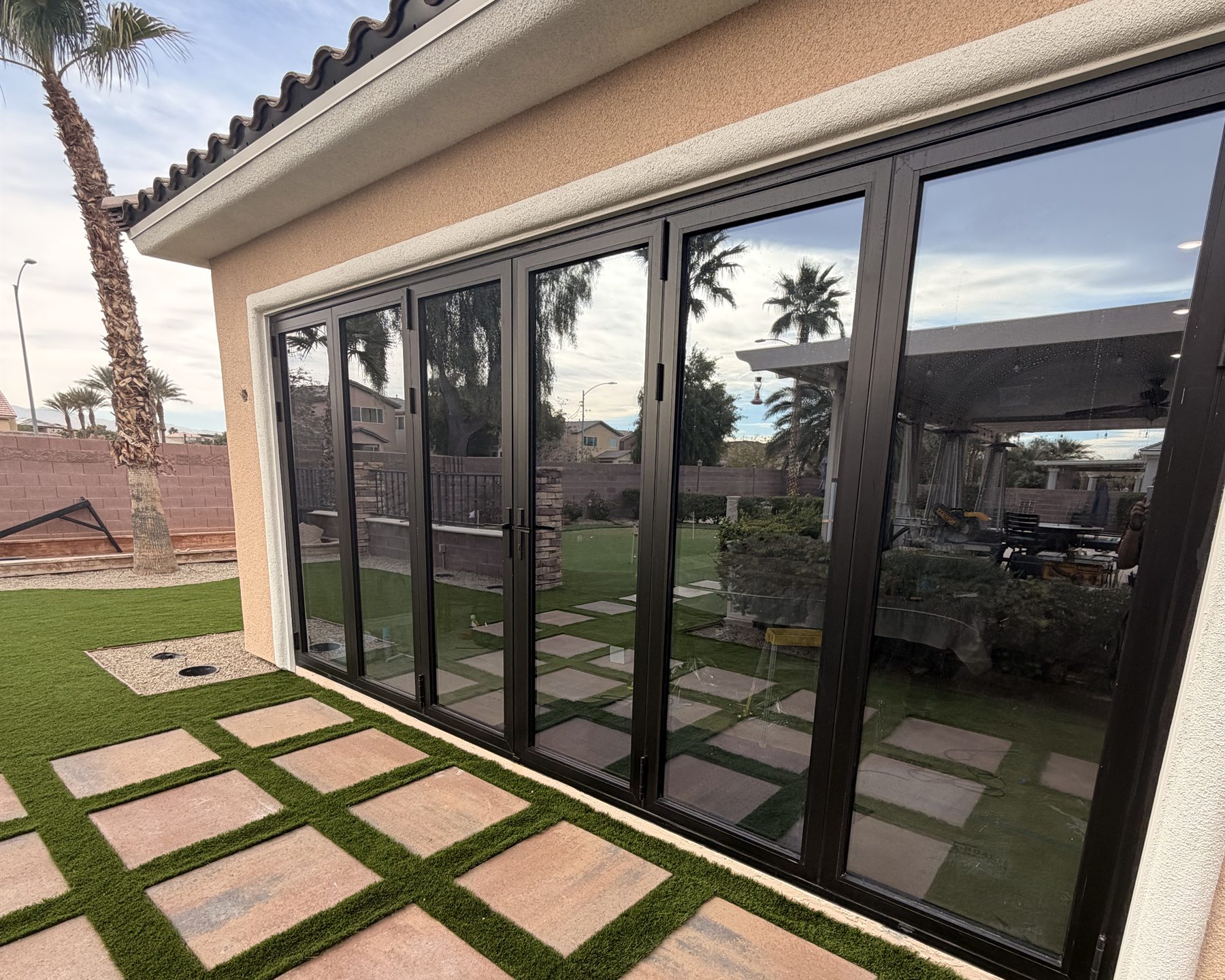 Large black-framed residential glass doors with a clean, uniform window film finish
