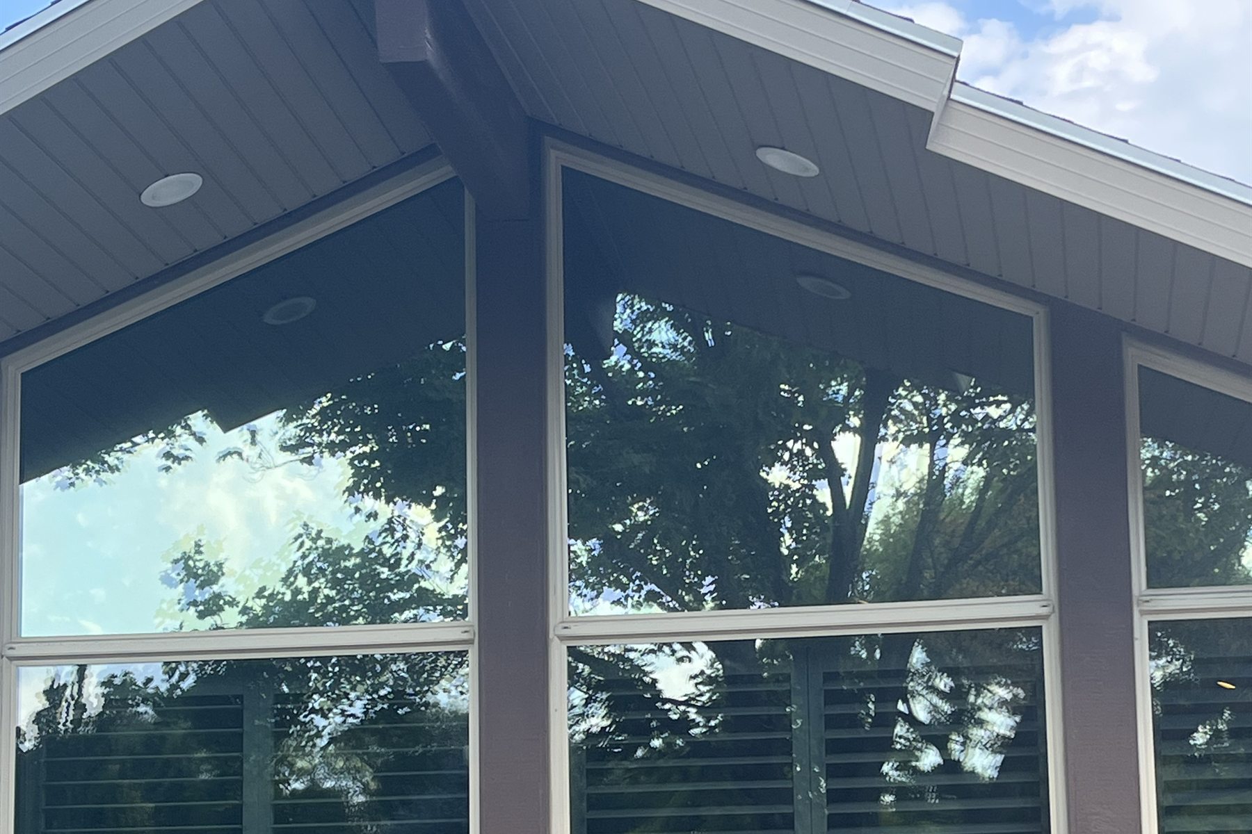 Tall architectural home windows with reflective window film
